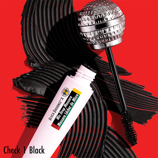  "Black Radiance x Cross Colours Mic Drop Mascara in 'Check 1 Black' with a microphone-shaped wand and bold black pigment swipes on a red background.