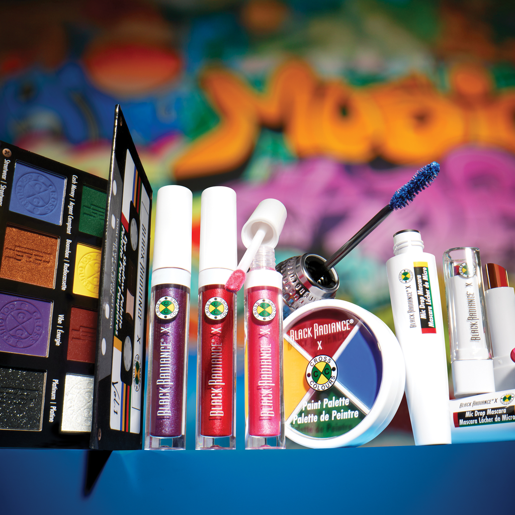 Makeup products including lipsticks, a paint palette, and a mascara with a colorful background.